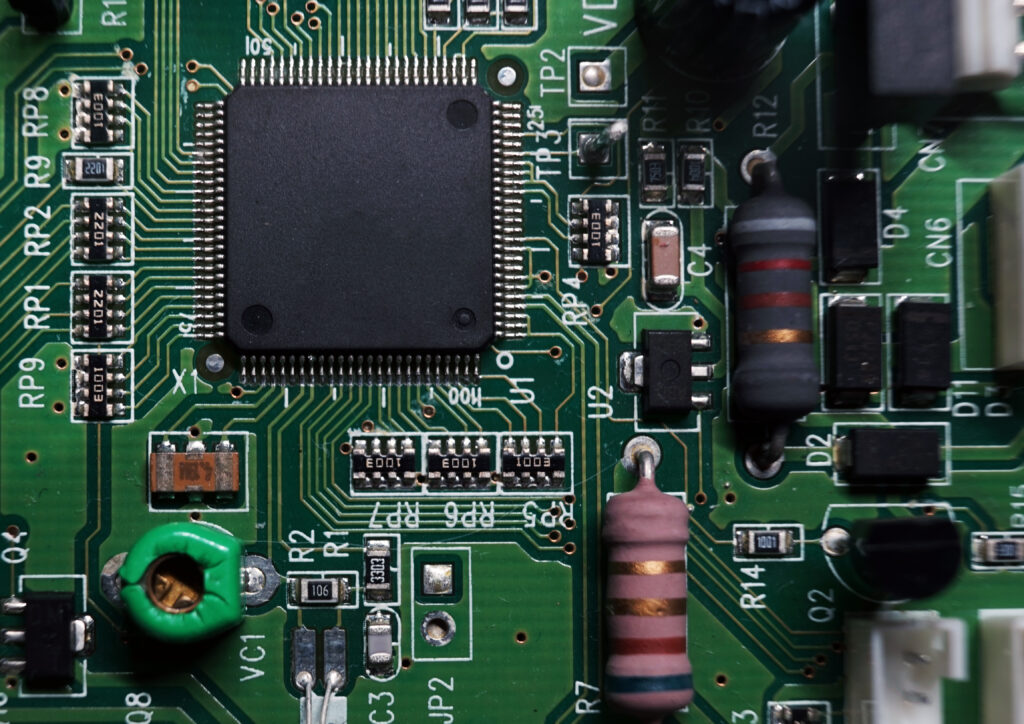 Printed Circuit Board with many electrical components. Selected focus.